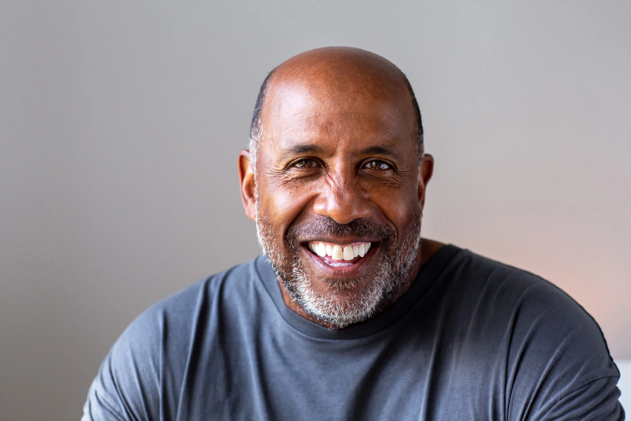 Smiling man in a gray t-shirt